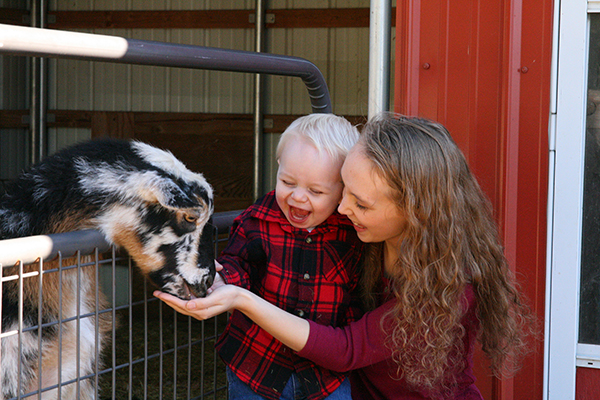 Photography mom child feeding goat